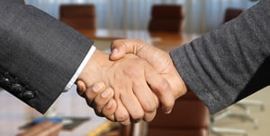 Two business men shaking hands.